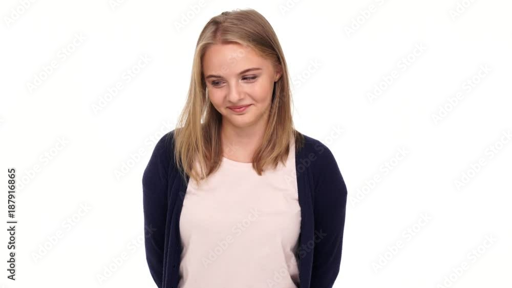 Happy shy blonde woman in cardigan looking at the camera over white background
Happy shy blonde woman in cardigan looking at the camera over white background
