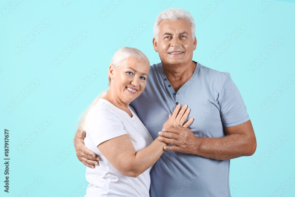 Mature couple against color background Mature couple against color background
