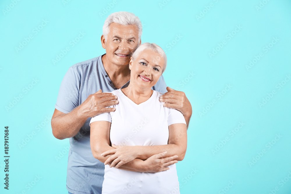 Mature couple against color background Mature couple against color background