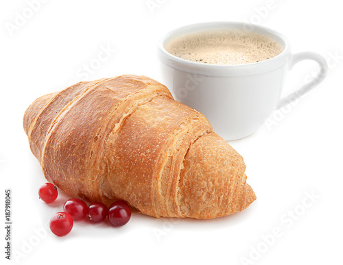 Yummy fresh croissant with cranberry and cup of coffee on white background