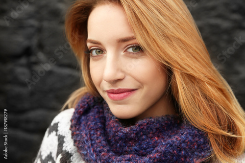 Beautiful smiling woman on dark background © Africa Studio