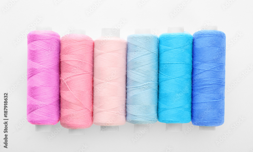 Many colorful threads on white background, top view Many colorful threads on white background, top view