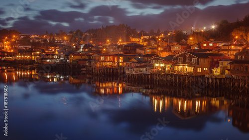 Night image of the traditional wooden houses built on stilts  stilt houses  along the waters edge in Castro  Chiloe  Chile