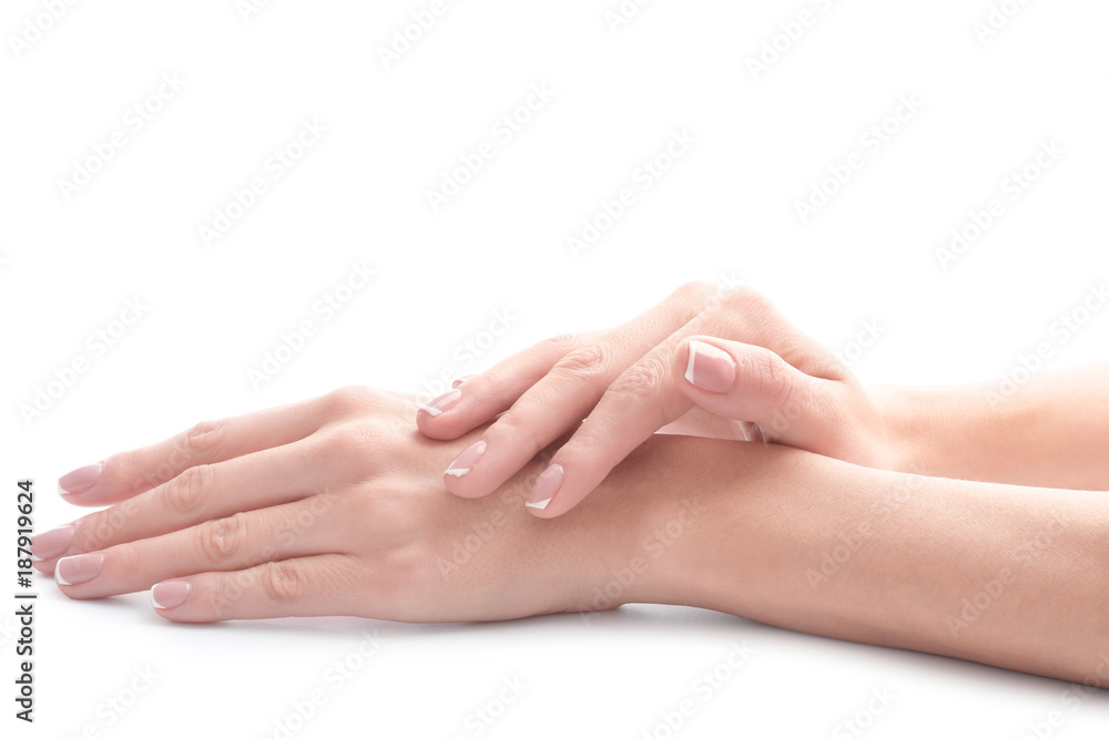 Young woman touching her hand and feeling moisturizing effect of cream on white background Young woman touching her hand and feeling moisturizing effect of cream on white background