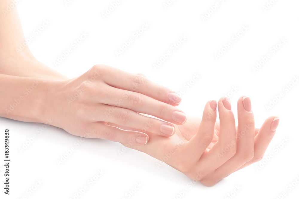 Young woman touching her hand and feeling moisturizing effect of cream on white background Young woman touching her hand and feeling moisturizing effect of cream on white background