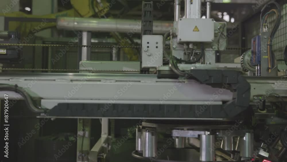Machine Takes Tire Rim Transfers to Mark in Plant Closeup Machine Takes Tire Rim Transfers to Mark in Plant Closeup