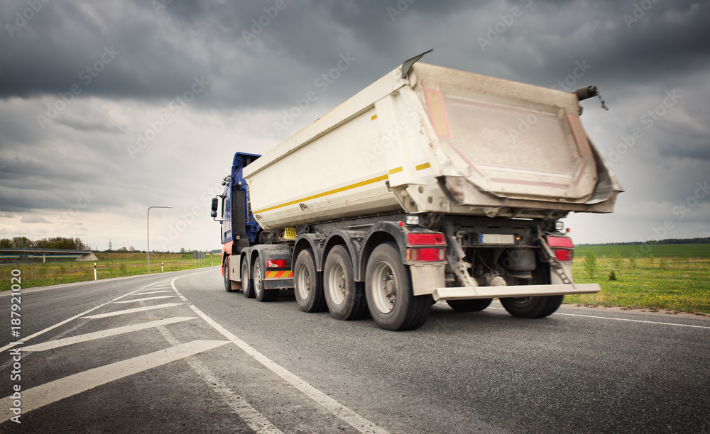 truck on asphalt road. lorry delivering cargo Stock Photo Adobe Stock