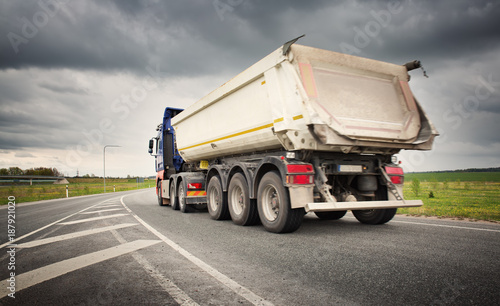 truck on asphalt road. lorry delivering cargo
