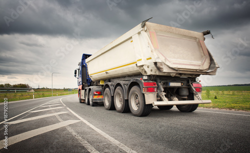 truck on asphalt road. lorry delivering cargo photo