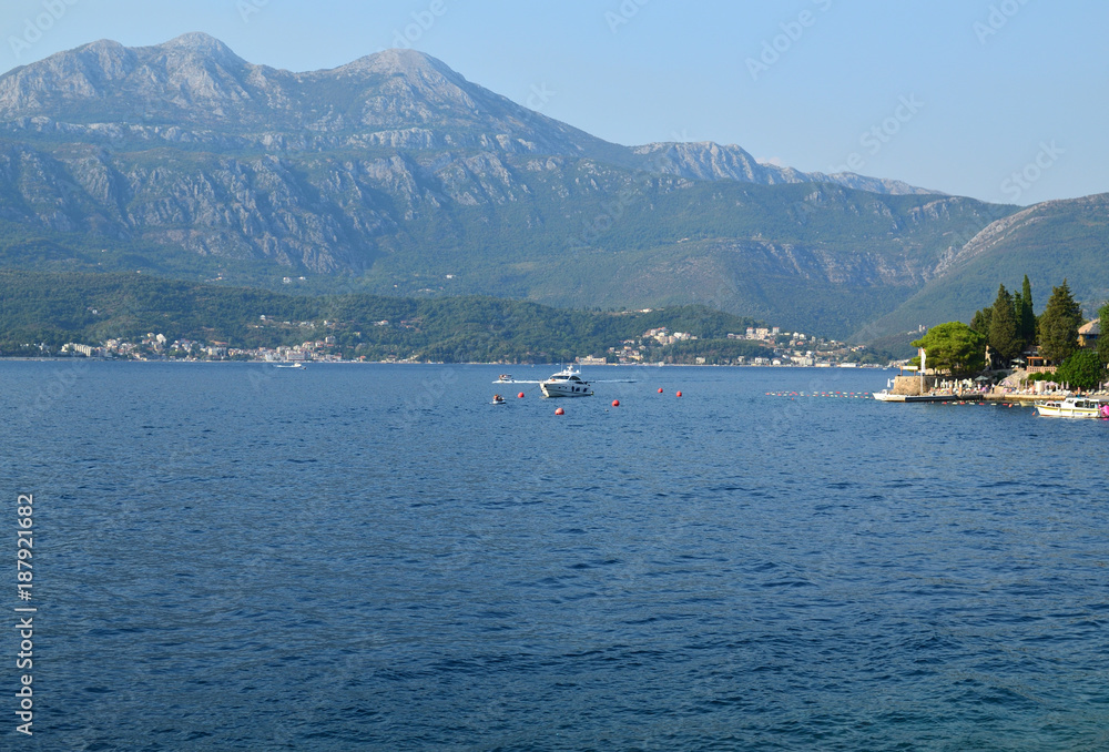 Part of beautiful Bay of Kotor with blue sea water of the Adriatic sea and hills in summertime