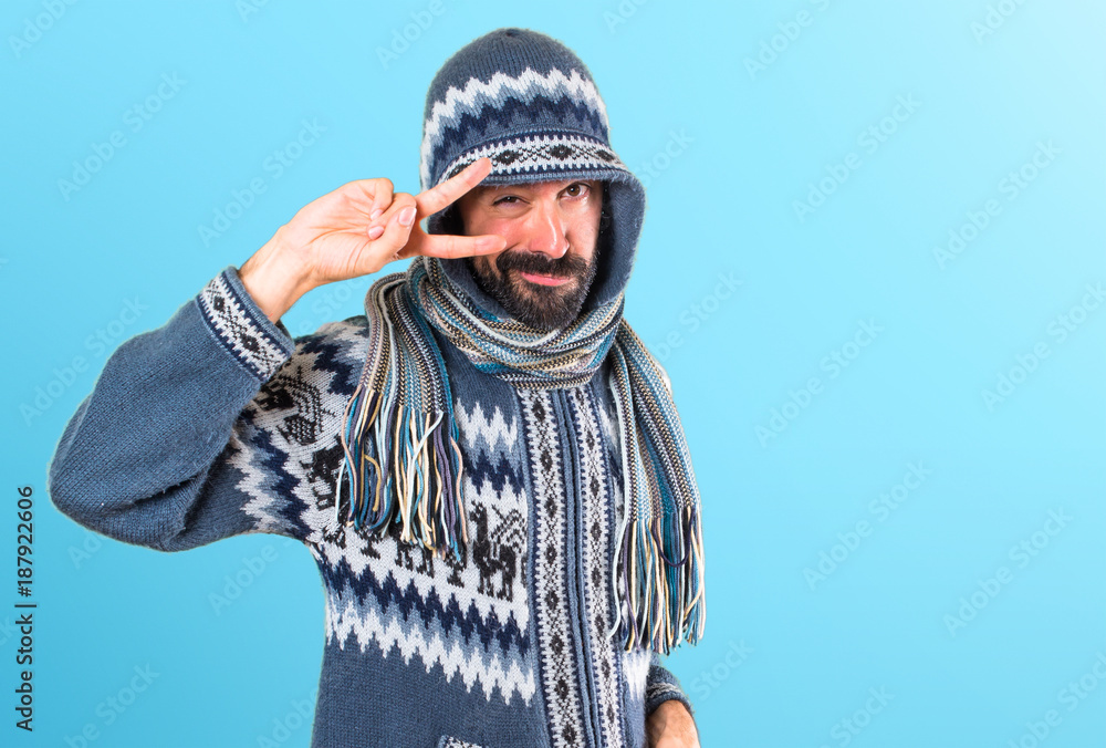 Man with winter clothes dancing on colorful background Man with winter clothes dancing on colorful background