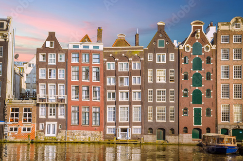 Traditional old buildings and and boats in Amsterdam, Netherlands. Canals of Amsterdam.