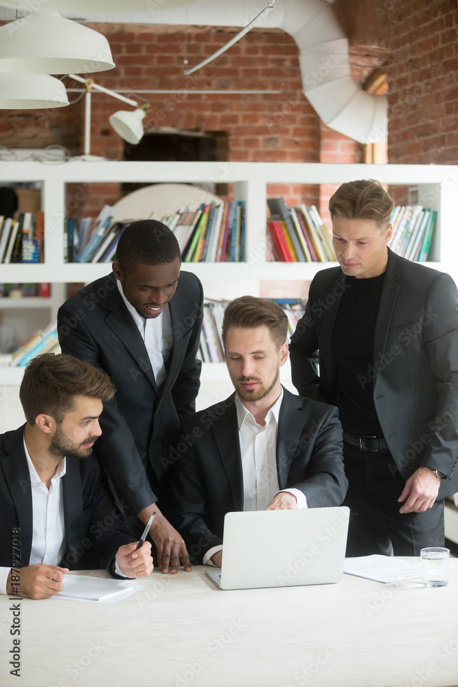 African and caucasian businessmen in suits talk share ideas with laptop ...