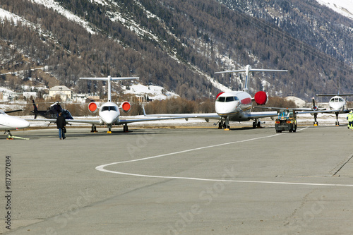 Private jets, planes and helicopters in the airport of St Moritz Switzerland in the alps