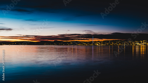 Fjord in the night with city in the background