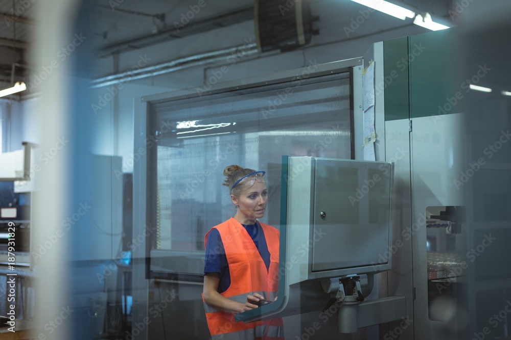 Female worker operating machine Female worker operating machine
