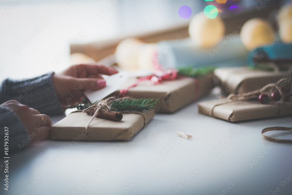 Hands of woman decorating christmas gift box. Hands of woman. Christmas.