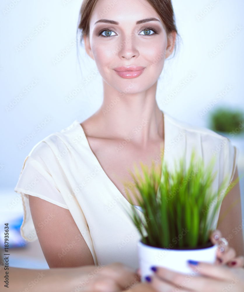 Attractive businesswoman standing near wall in office Attractive businesswoman standing near wall in office