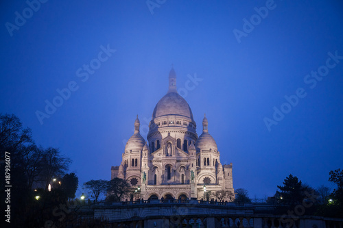 Sacre Coeur Basilica in Montmartre, Paris, illuminated during a winter night. The Basilica of the Sacred Heart of Paris is a Roman Catholic church and minor basilica..