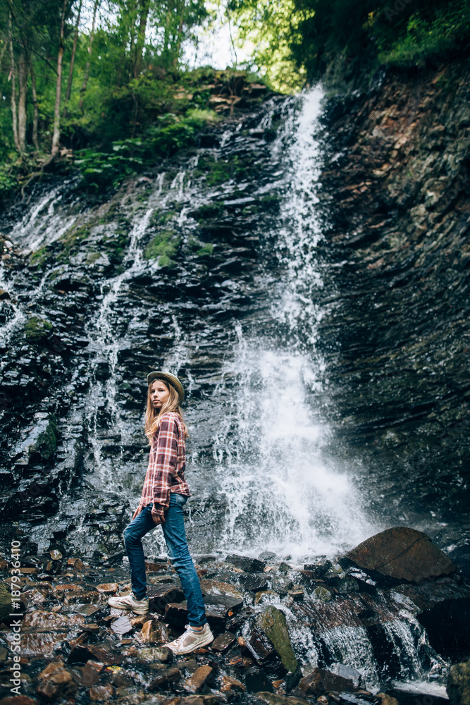 Portrait of young girl near waterfall