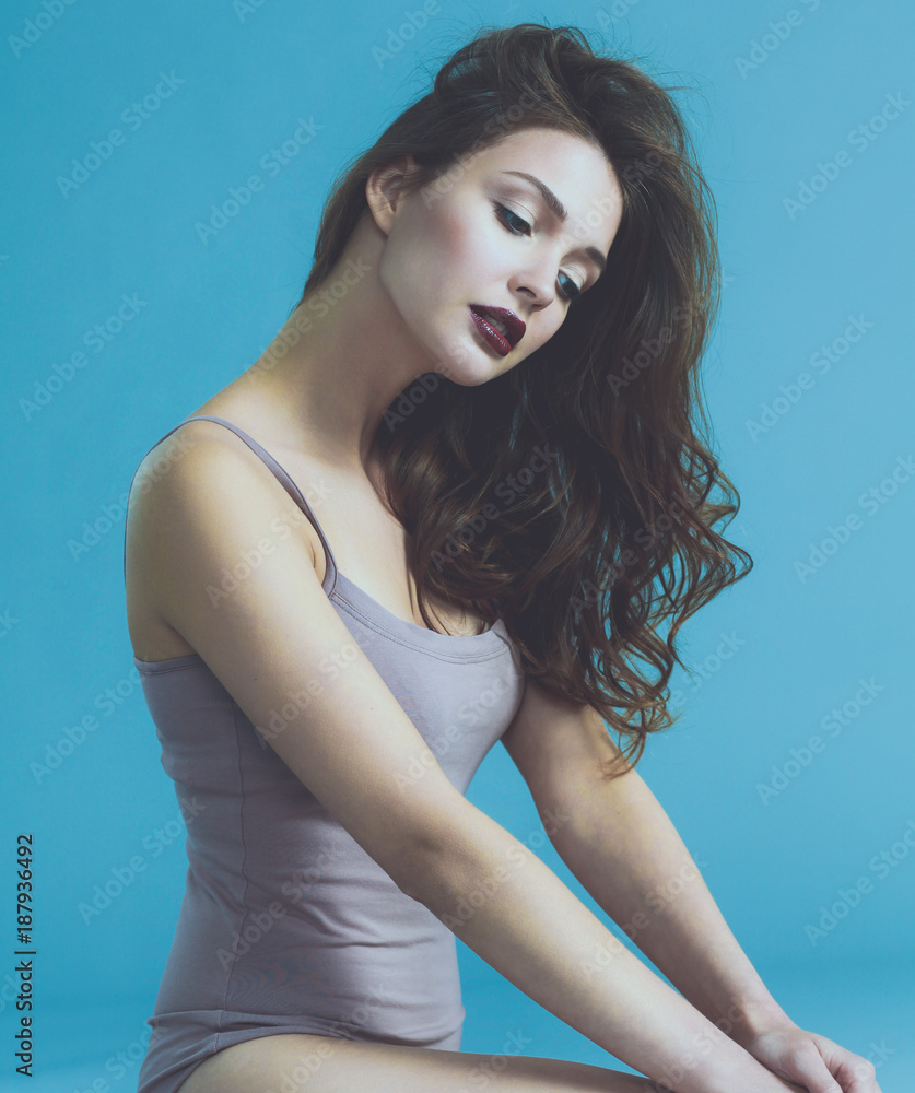 Fototapeta premium Beautiful barefoot woman sitting on the floor