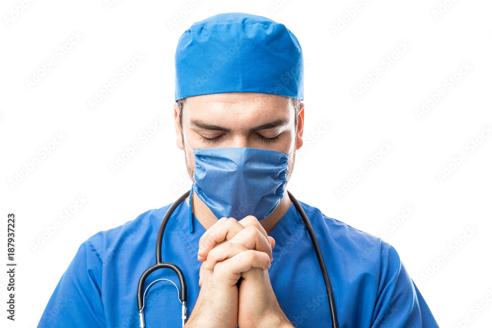 Doctor saying a prayer before surgery Doctor saying a prayer before surgery