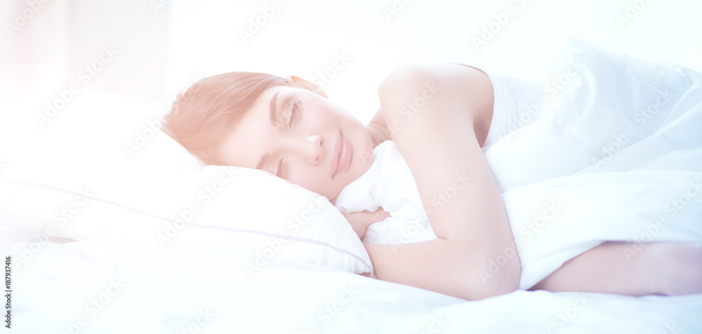 Beautiful girl sleeps in the bedroom, lying on bed Beautiful girl sleeps in the bedroom, lying on bed