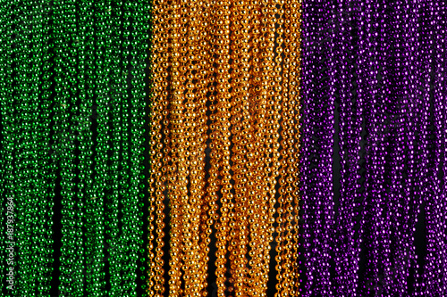 Green, gold, and purple Mardi Gras beads background