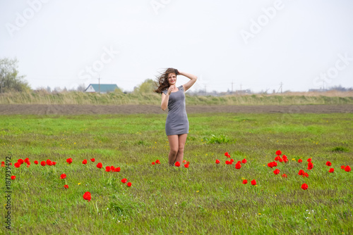 Fototapeta Naklejka Na Ścianę i Meble -  Beautiful fairy young girl in a field among the flowers of tulip