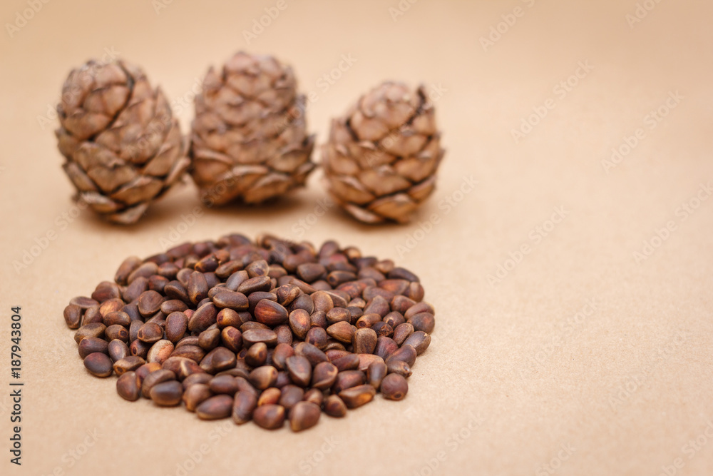 Pine nuts and cones on craft paper background Pine nuts and cones on craft paper background