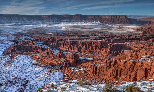 Sandstone formations under snow in Professor Valley near Moab. Fisher towers. Utah. United States.
