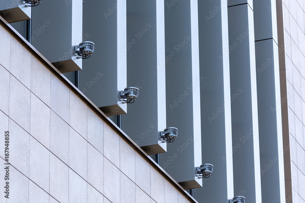 A number of beautiful lamps illuminating the Windows of a large building A number of beautiful lamps illuminating the Windows of a large building