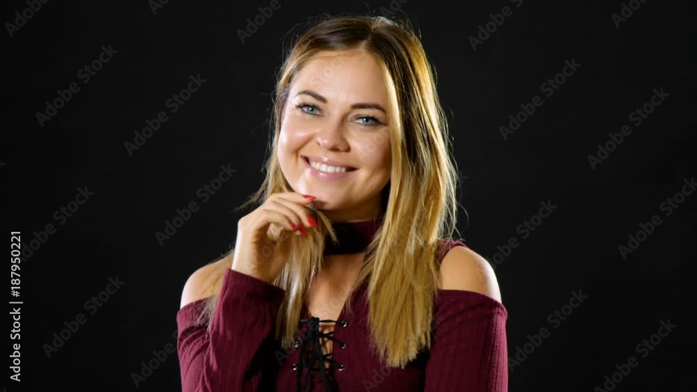 Pretty blond woman smiling and acting playful. Pretty blond woman smiling and acting playful.