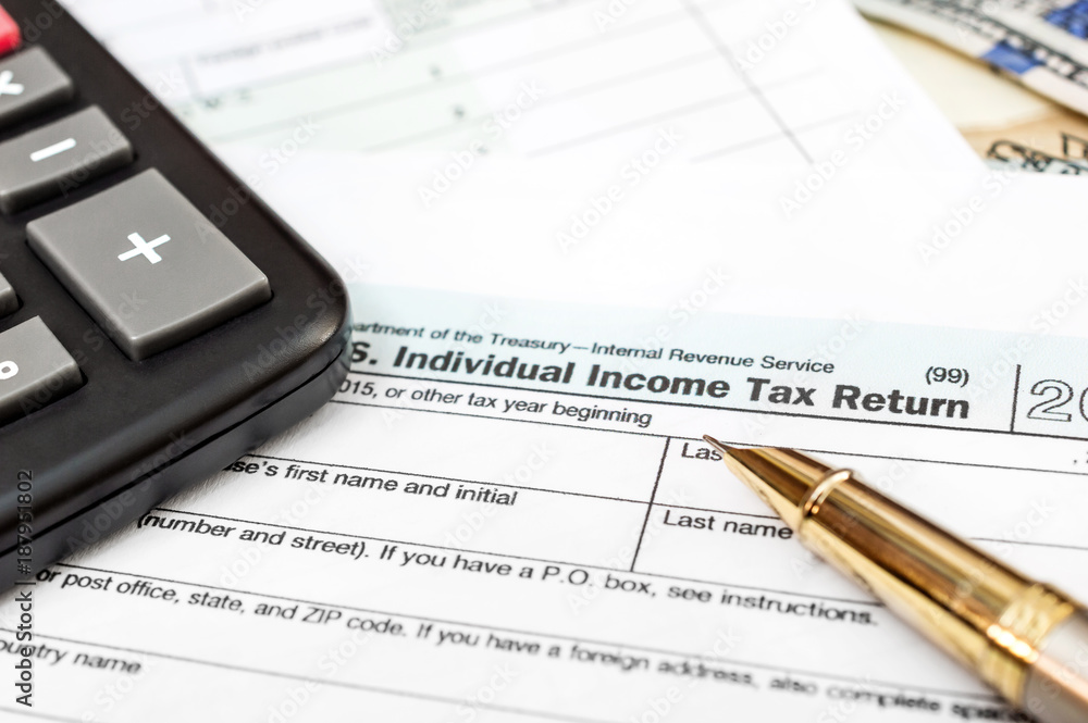 Tax form with calculator, pen and money. Close up. Tax form with calculator, pen and money. Close up.