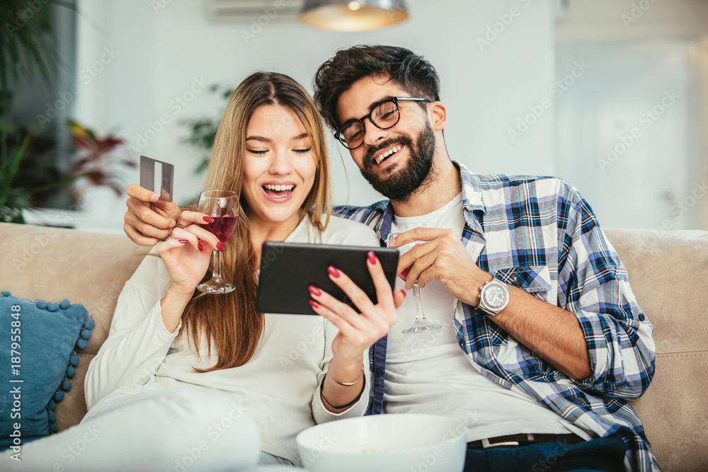technology, online shopping and people concept - smiling happy couple couple with tablet pc computer and credit card at home technology, online shopping and people concept - smiling happy couple couple with tablet pc computer and credit card at home