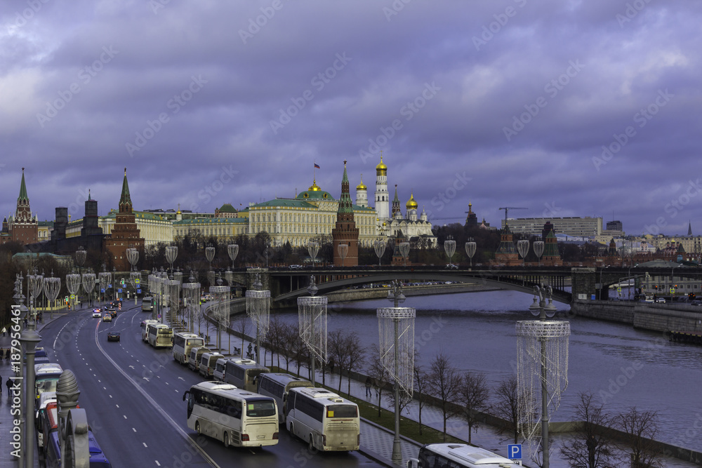 View of the Kremlin from the Patriarchal bridge . Parked tour buses in the foreground. View of the Kremlin from the Patriarchal bridge . Parked tour buses in the foreground.