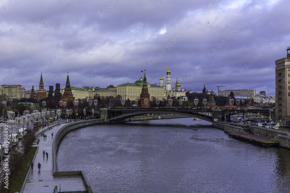 View of the Kremlin from the Patriarchal bridge . Parked tour buses in the foreground.Thaw in the middle of winter.