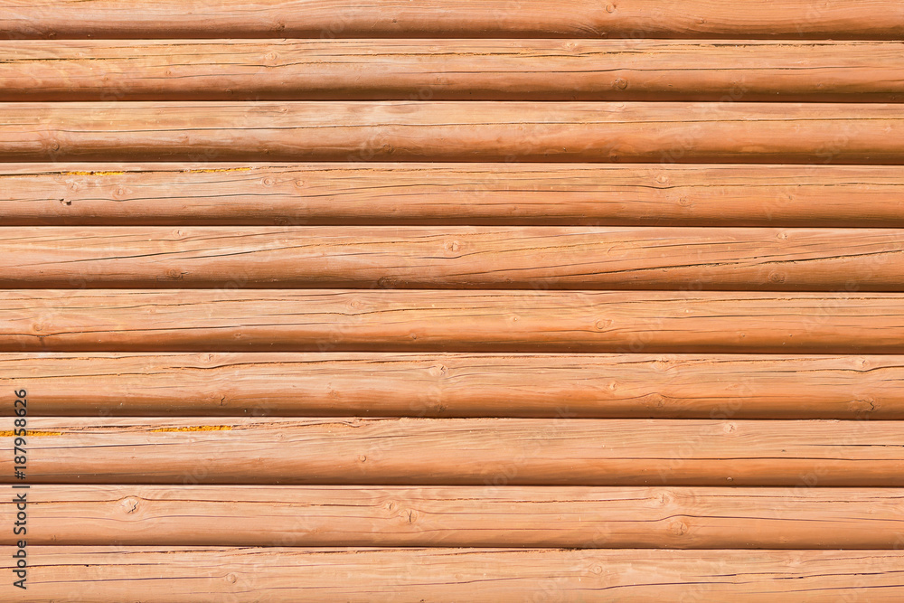wooden wall from horizontally arranged logs, background texture wooden wall from horizontally arranged logs, background texture