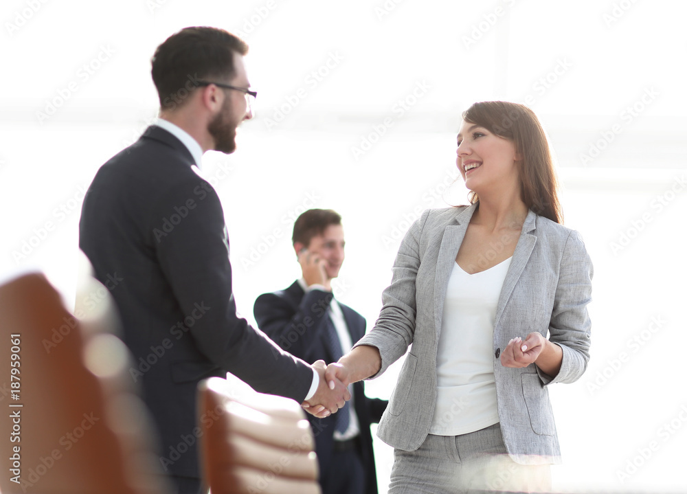 handshake between colleagues in the workplace handshake between colleagues in the workplace