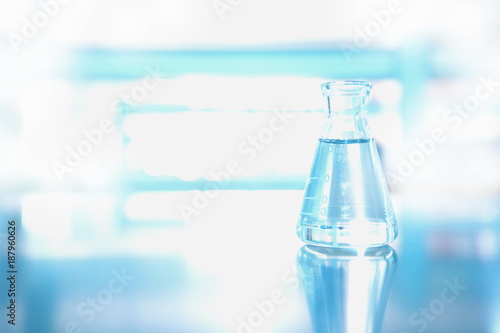 single flask with water in science chemical environment laboratory