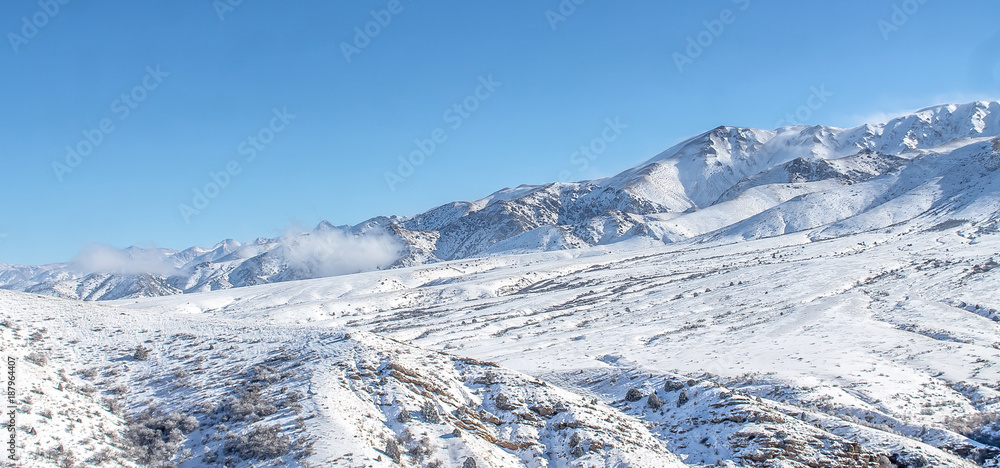 Clouds on snow-capped mountains