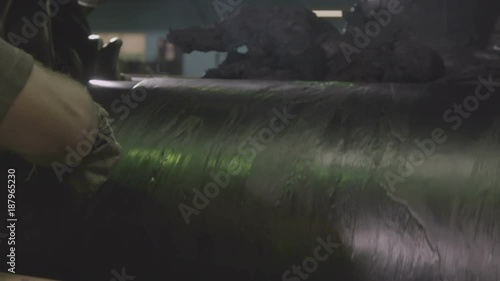 Rubber Pieces Drop into Caoutchouc Roller Mixer Closeup