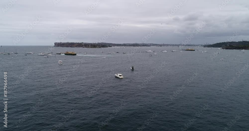 Super maxi sailing boats of Sydney Hobart yacht race clearing from Sydney harbour after start surrounded by spectator boasts and passenger ships.
Super maxi sailing boats of Sydney Hobart yacht race clearing from Sydney harbour after start surrounded by spectator boasts and passenger ships.