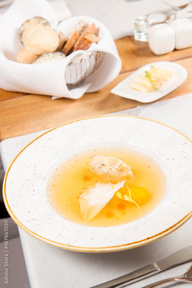 Dumplings in broth with an egg yolk served in a restaurant Dumplings in broth with an egg yolk served in a restaurant