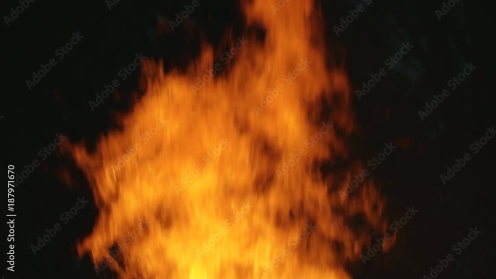slow motion shot of large firewood burning, wildfire, bonfire at black bckground, ashes and damage, festive fire, ritual, close up slow motion shot of large firewood burning, wildfire, bonfire at black bckground, ashes and damage, festive fire, ritual, close up