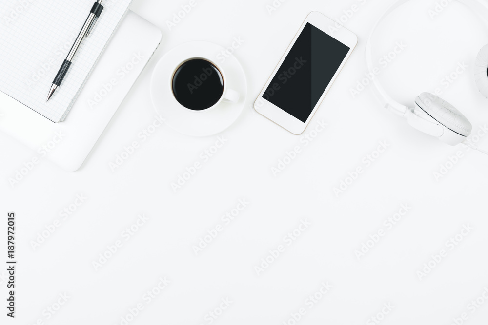 Creative white table with blank cellphone Creative white table with blank cellphone