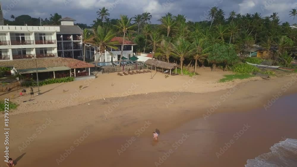 Girl with baby at beach ocean sunset drone footage Girl with baby at beach ocean sunset drone footage