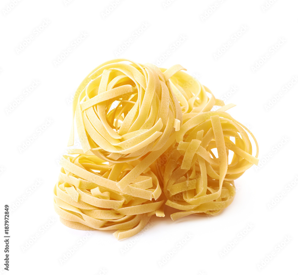 Uncooked fettuccine pasta isolated Uncooked fettuccine pasta isolated