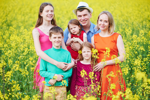 Big family in summer field outdoors.