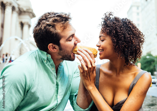 Photography Happy couple eating hot dogs and having fun in New york city